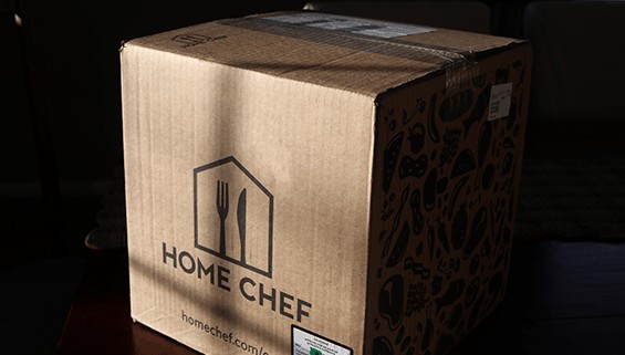 Home Chef delivery box filled with meal kit sitting on