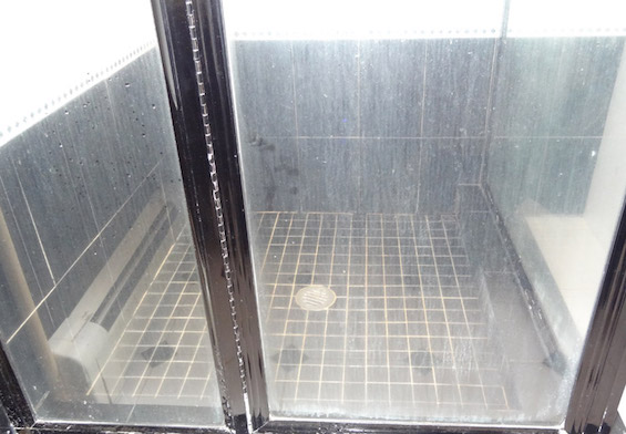 How do you remove hard water stains from glass shower doors