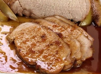 A plate of food, with Pork and Sauce