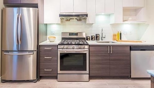 A kitchen with a stove top oven sitting inside of a refrigerator