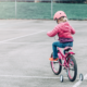 Little Girl on Bike with Training Wheels