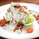 blue cheese wedge salad with salad dressing tomatoes bacon crumbles