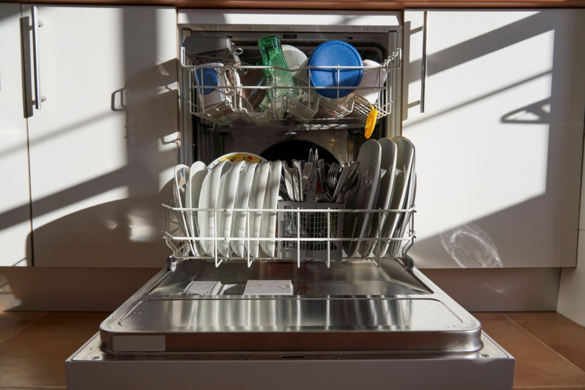front view of dishes and utensils in a dishwasher