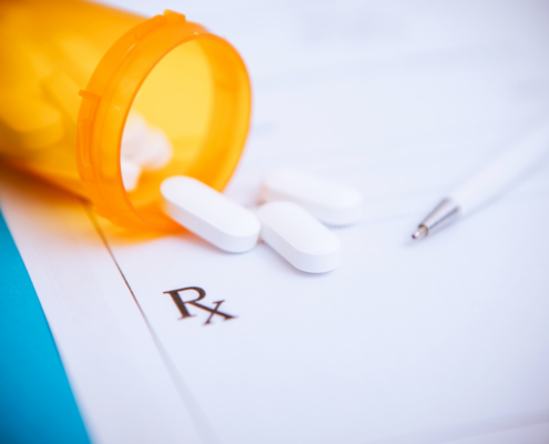 prescription drug costs spilling onto notepad RX