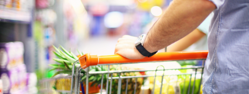 how to save money on groceries saving on food man pushing shopping cart with pineapple