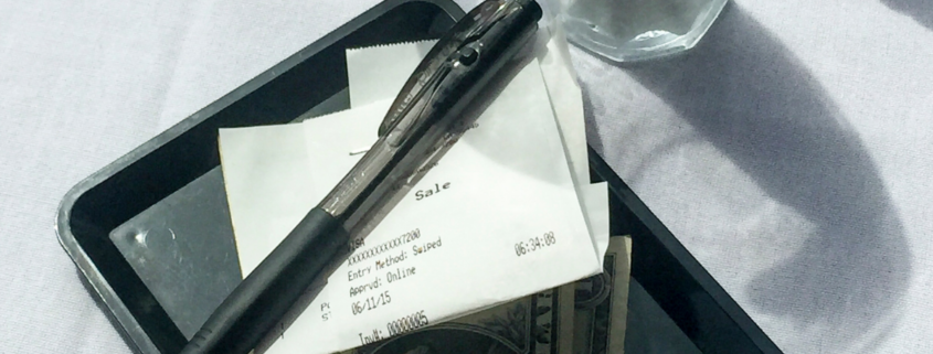 how much to tip tipping etiquette restaurant receipt with pen and dollar bills
