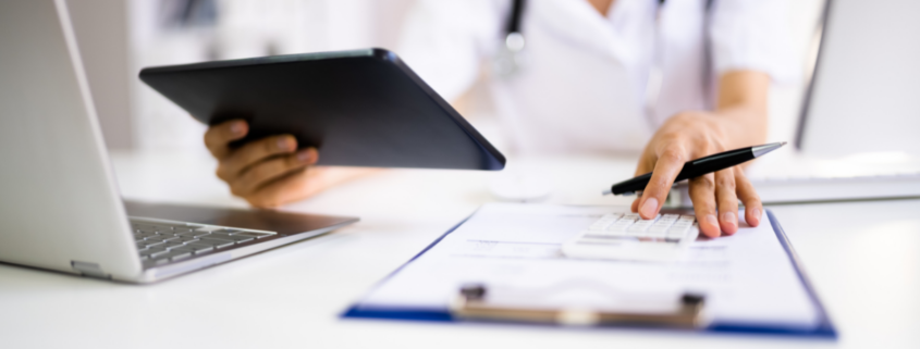 medical bills healthcare costs female worker with laptop tablet and clipboard