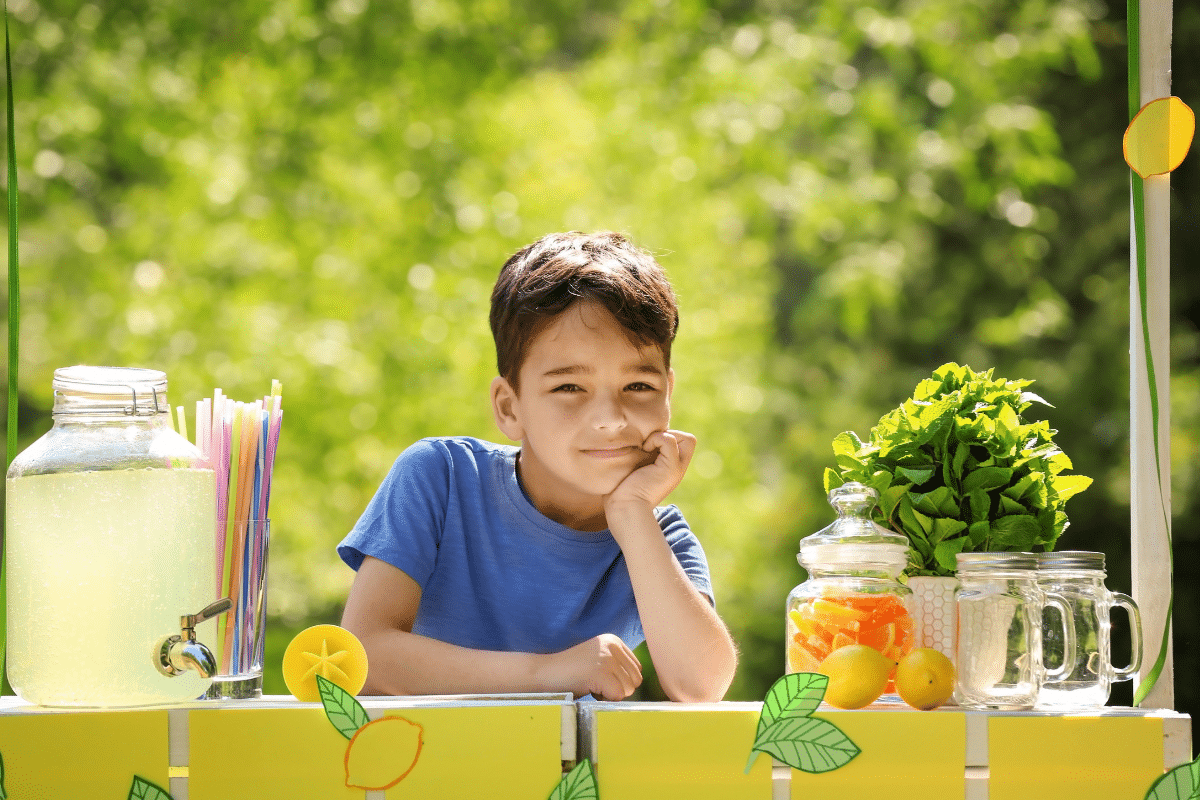 boy hosting a lemonade stand