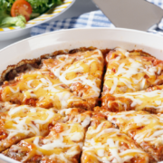 Impossible Lasagna Pie round casserole with cheese and marinara top