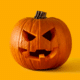 halloween on a budget jack o lantern pumpkin on solid yellow background