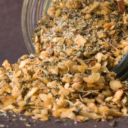 homemade garlic seasoning blend pouring out of glass jar