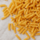 a pile of uncooked spiral pasta noodles