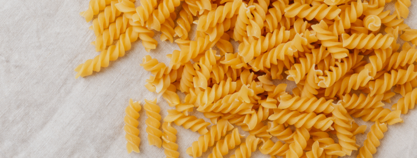 a pile of uncooked spiral pasta noodles