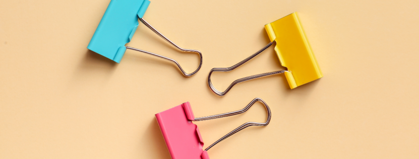 three colorful binder clips