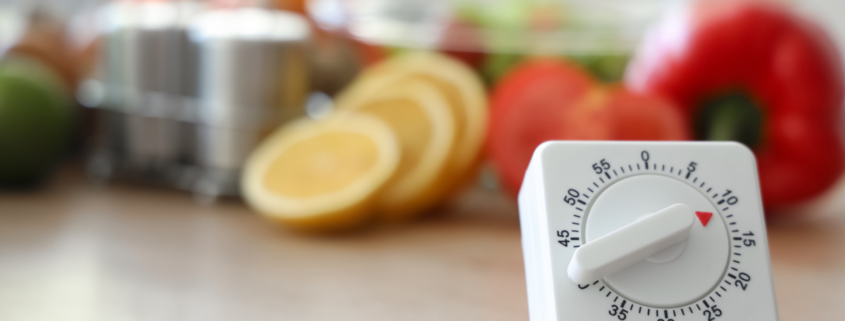 10-minute decluttering woman holding timer with kitchen in background