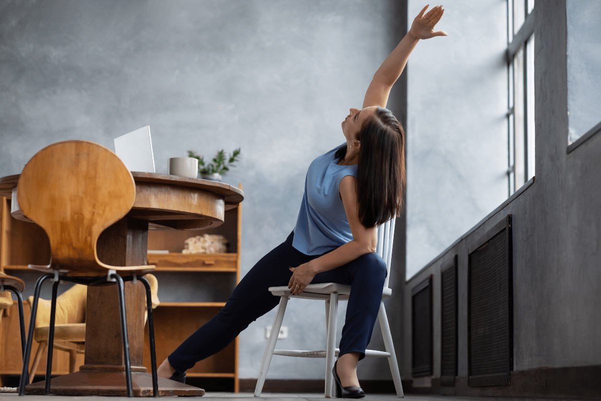 free chair yoga apps videos resources online woman in side stretch sitting in chair