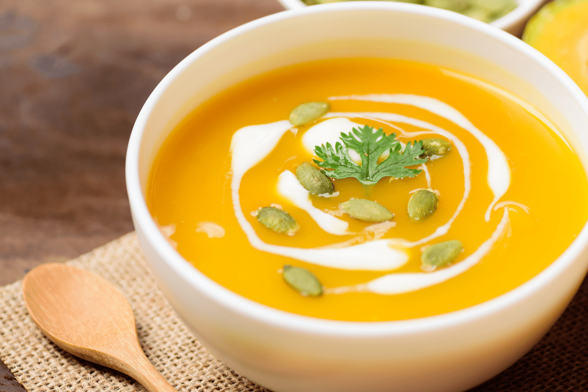 3 ingredient butternut squash soup closeup with crema and pepitas
