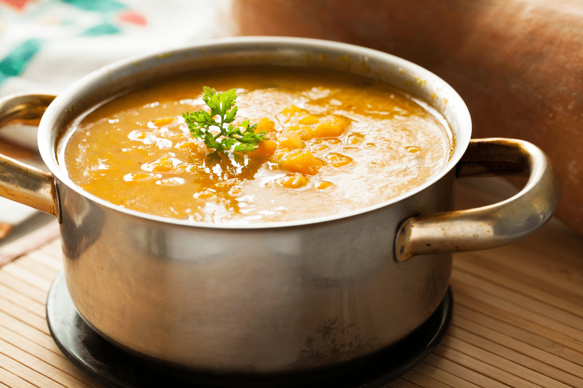 3-ingredient butternut squash soup recipe in pot with fresh herbs