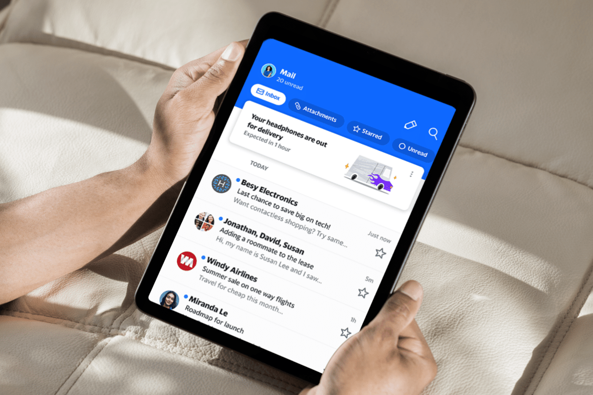 aol mail on tablet male hands holding with lights and shadows hitting couch