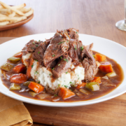 Instant Pot Rustic Beef & Vegetable Braise in white bowl served over white rice