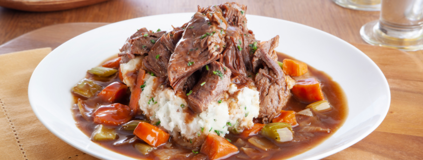 Instant Pot Rustic Beef & Vegetable Braise in white bowl served over white rice