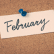 february written on paper pinned to cork board news you can use top news articles