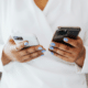 what to do with an old mobile phone woman holding black and white iphones