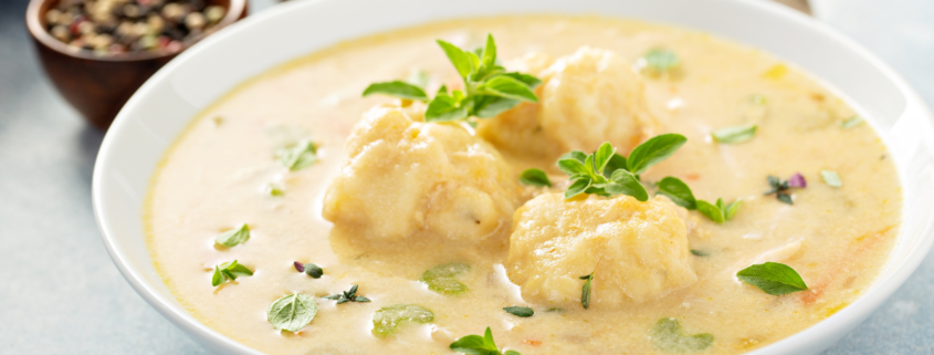 slow cooker chicken and dumpling soup creamy with garnish in bowl