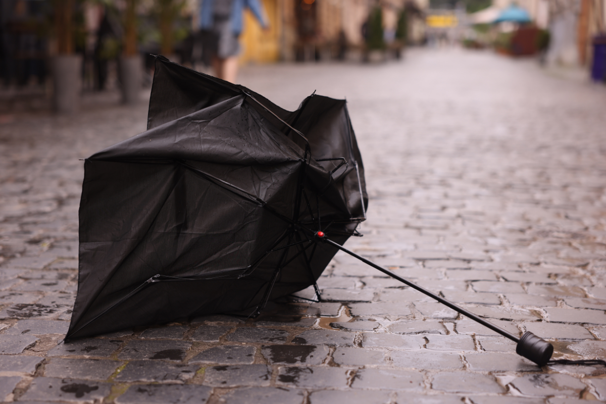 broken umbrella sitting on pavement
