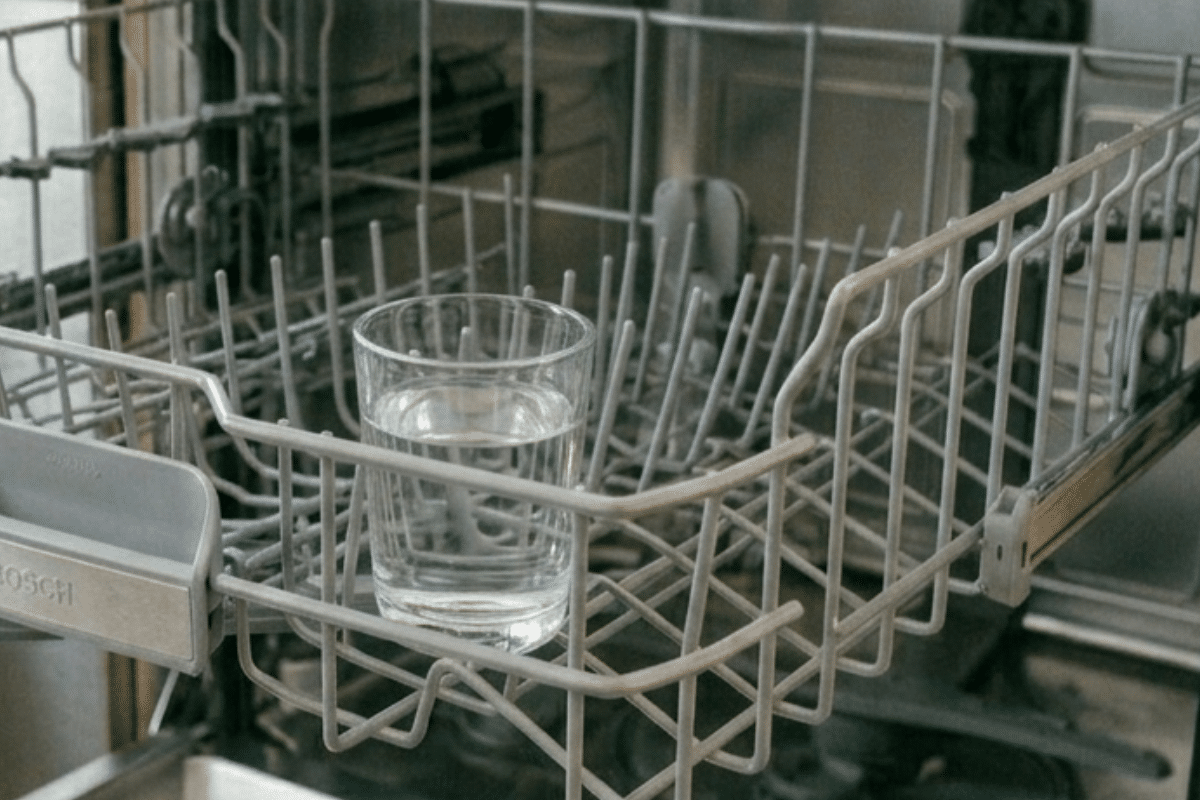 glass of white vinegar in dishwasher