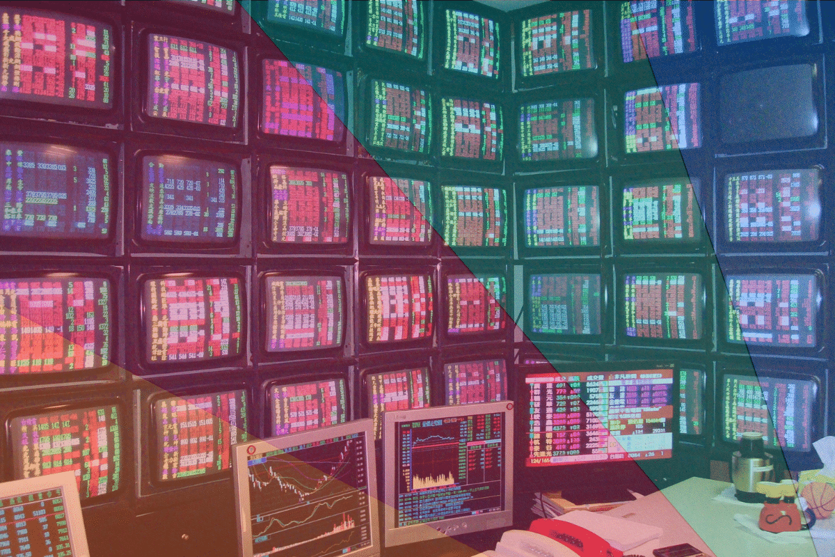 wall of tvs showing stock market analysis vintage news room old school monitors