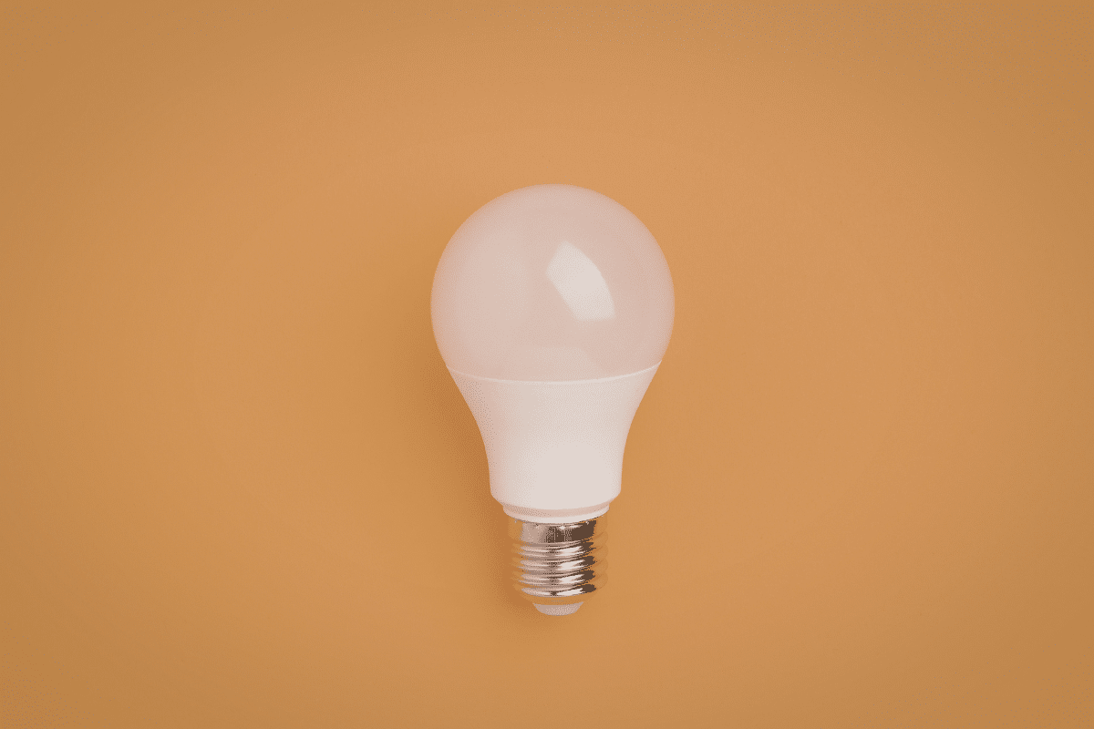 led bulb on orange background fight inflation at home