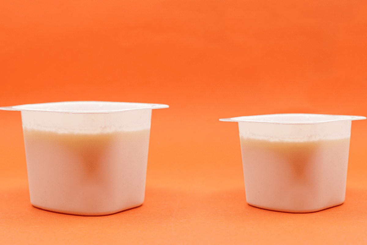 two yogurt cups showing shrinkflation comparison