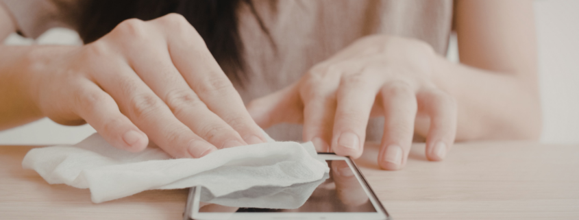 woman disinfecting iphone how to clean phone