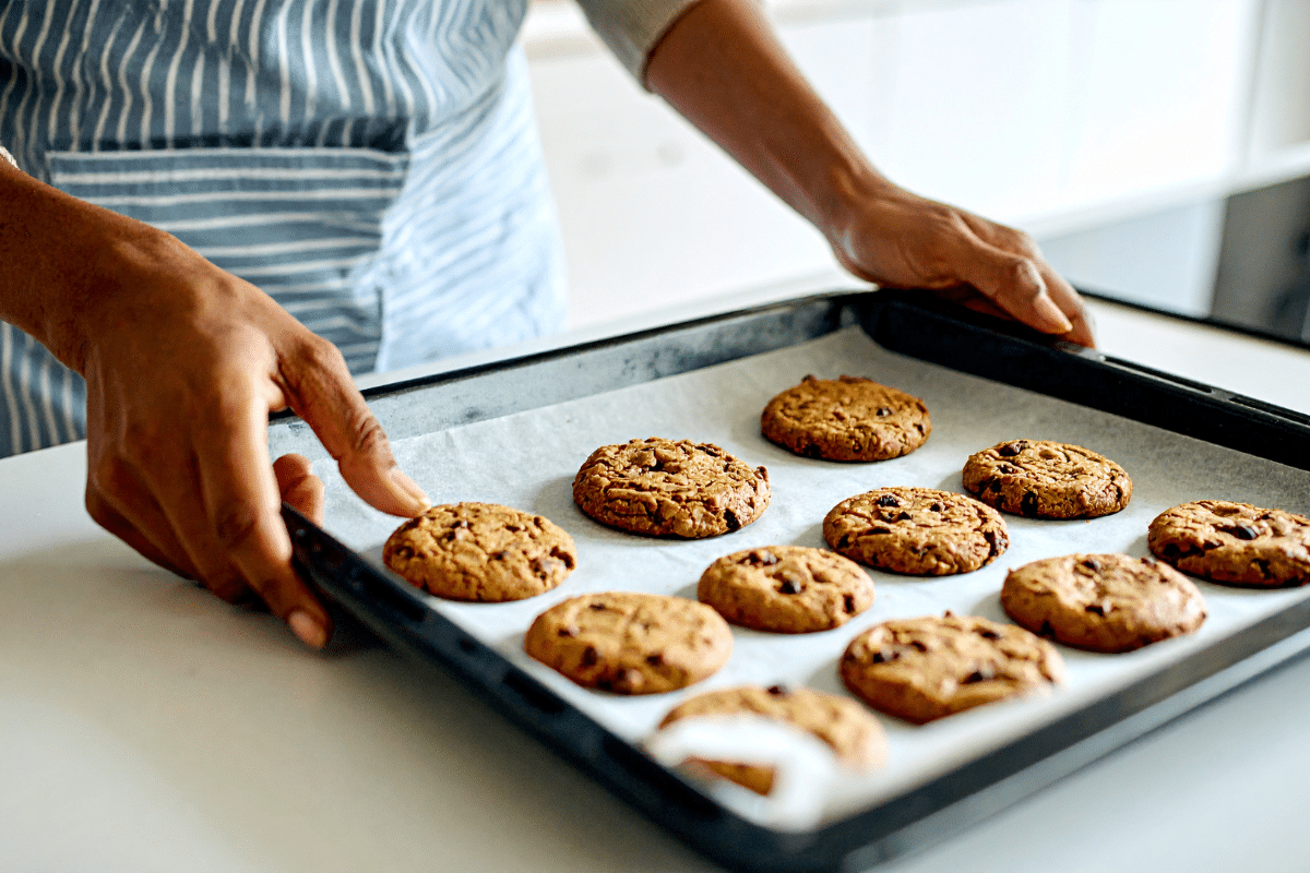 cookie sheet lined with parchment paper fresh batch of chocolate chip cookies