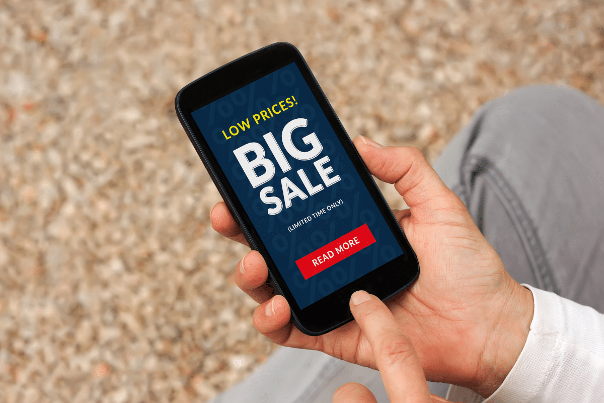 woman holding iphone online shopping a big sale limited time offer how materialism leads to discontentment