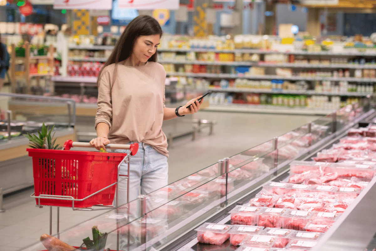 woman choosing ground beef in store grocery supermarket meat