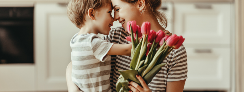 cheap Mother’s Day gift ideas mother holding son with tulip boquet in hands