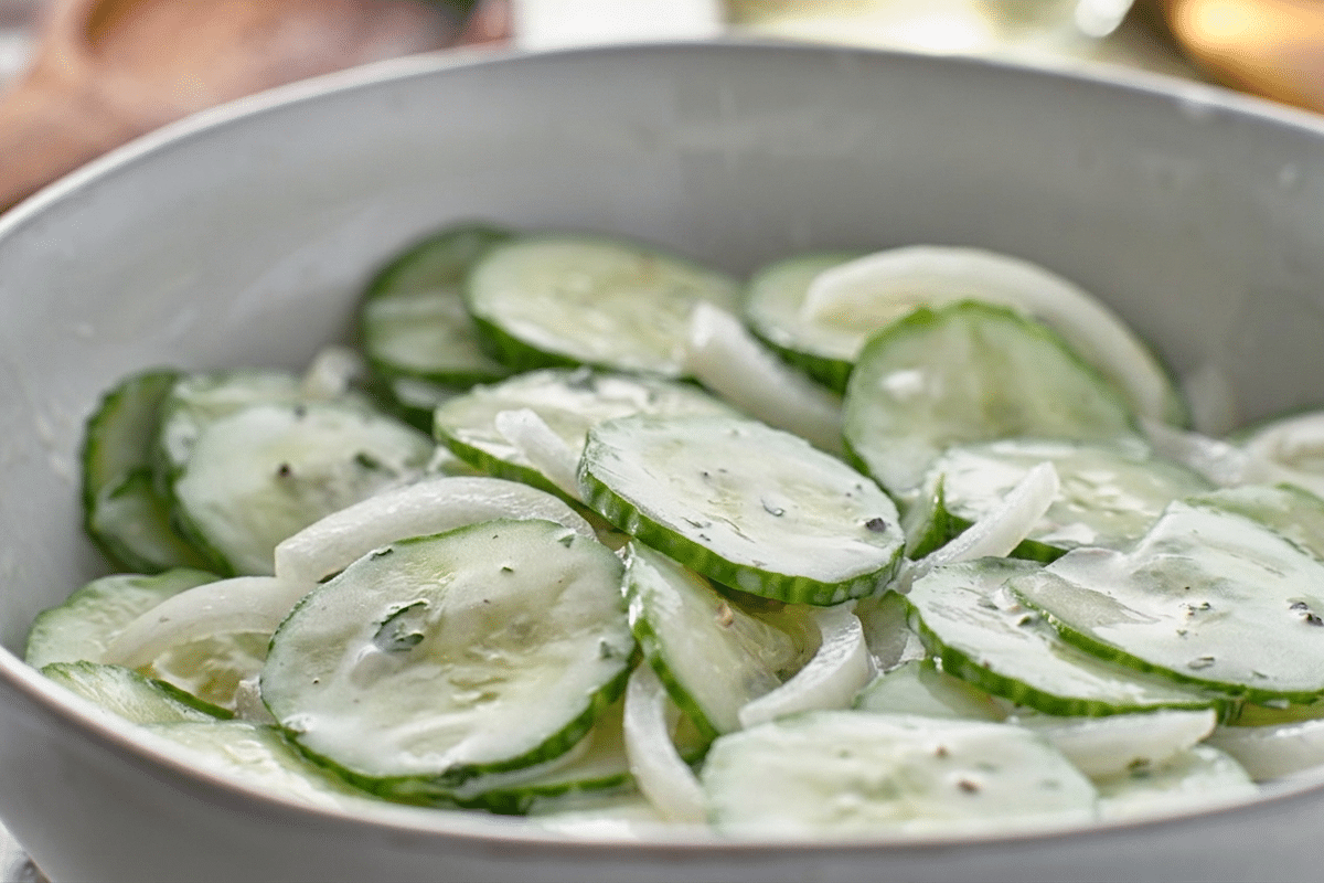 closeup of grandma's cucumber salad recipe in bowl with sweet white onions