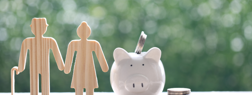 borrowing from your retirement account piggy bank and wood cutout of retired couple