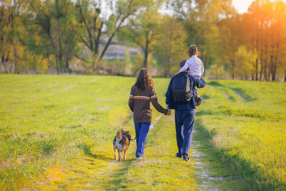 family walking on mothers day with dog outdoors