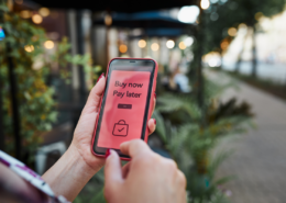 buy now pay later app on iphone in womans hands