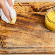 homemade beeswax furniture polish woman wiping cutting board