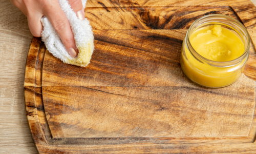 homemade beeswax furniture polish woman wiping cutting board