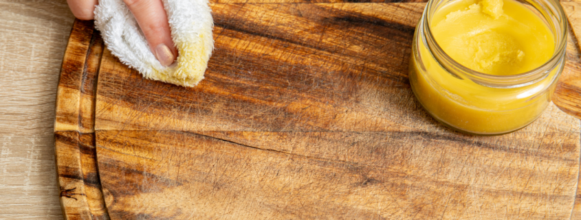 homemade beeswax furniture polish woman wiping cutting board