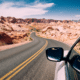 road trip car checklist car driving through the desert winding road with blue skies