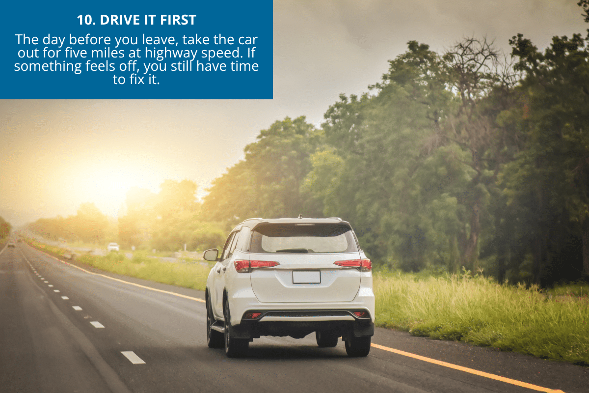test driving down the highway a white SUV at sunset