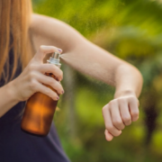 woman using an amber glass DIY mosquito repellent spray