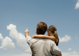 Father's Day activities on a budget dad and daughter pointing up to clouds in the blue sky
