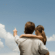 Father's Day activities on a budget dad and daughter pointing up to clouds in the blue sky